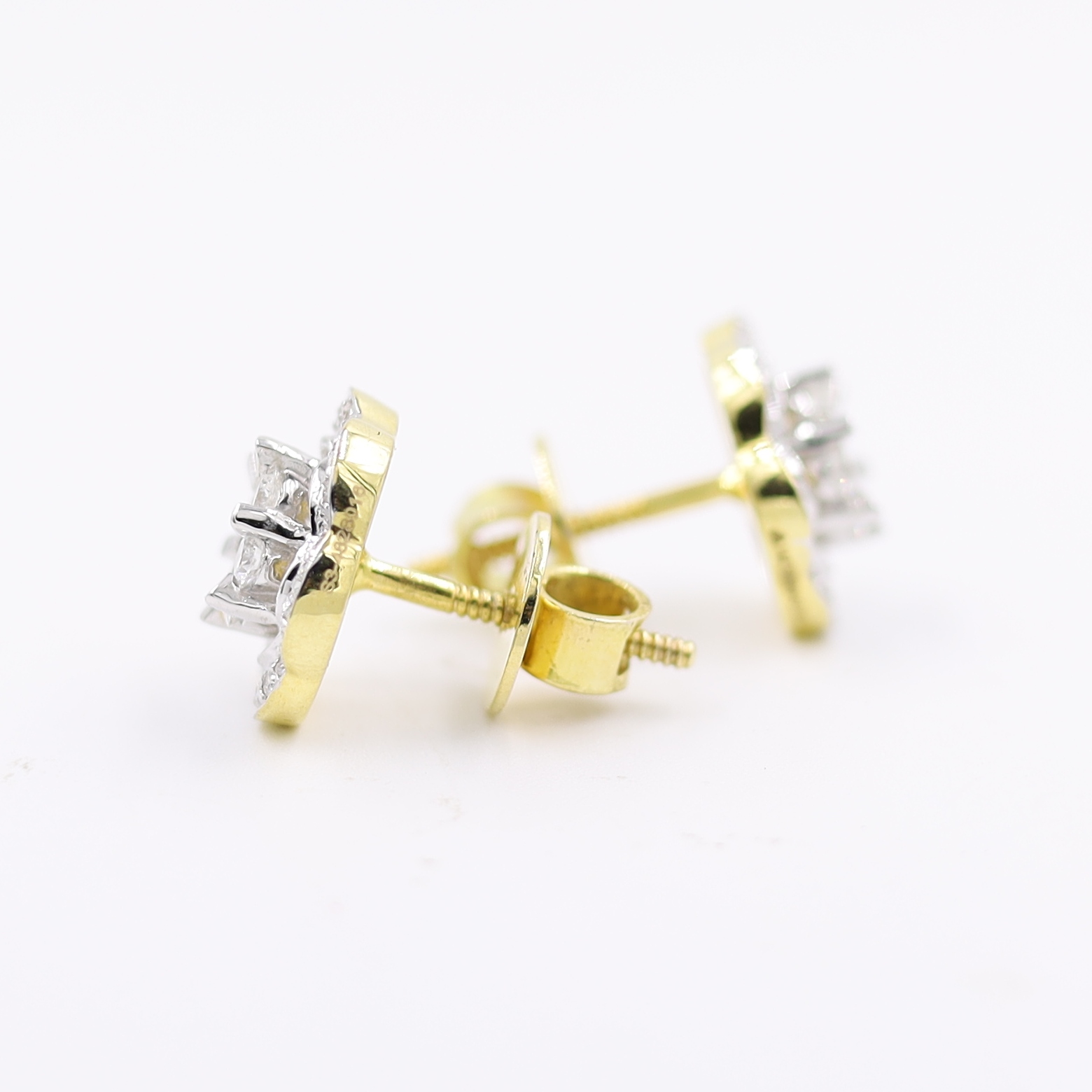 14kt Ethereal Floral Earrings topped with a round pressure-set diamond.