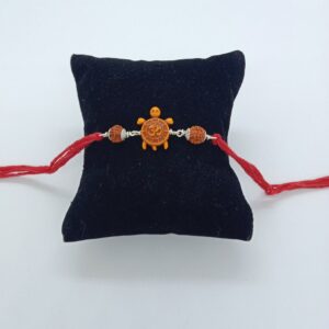 silver om design rakhi