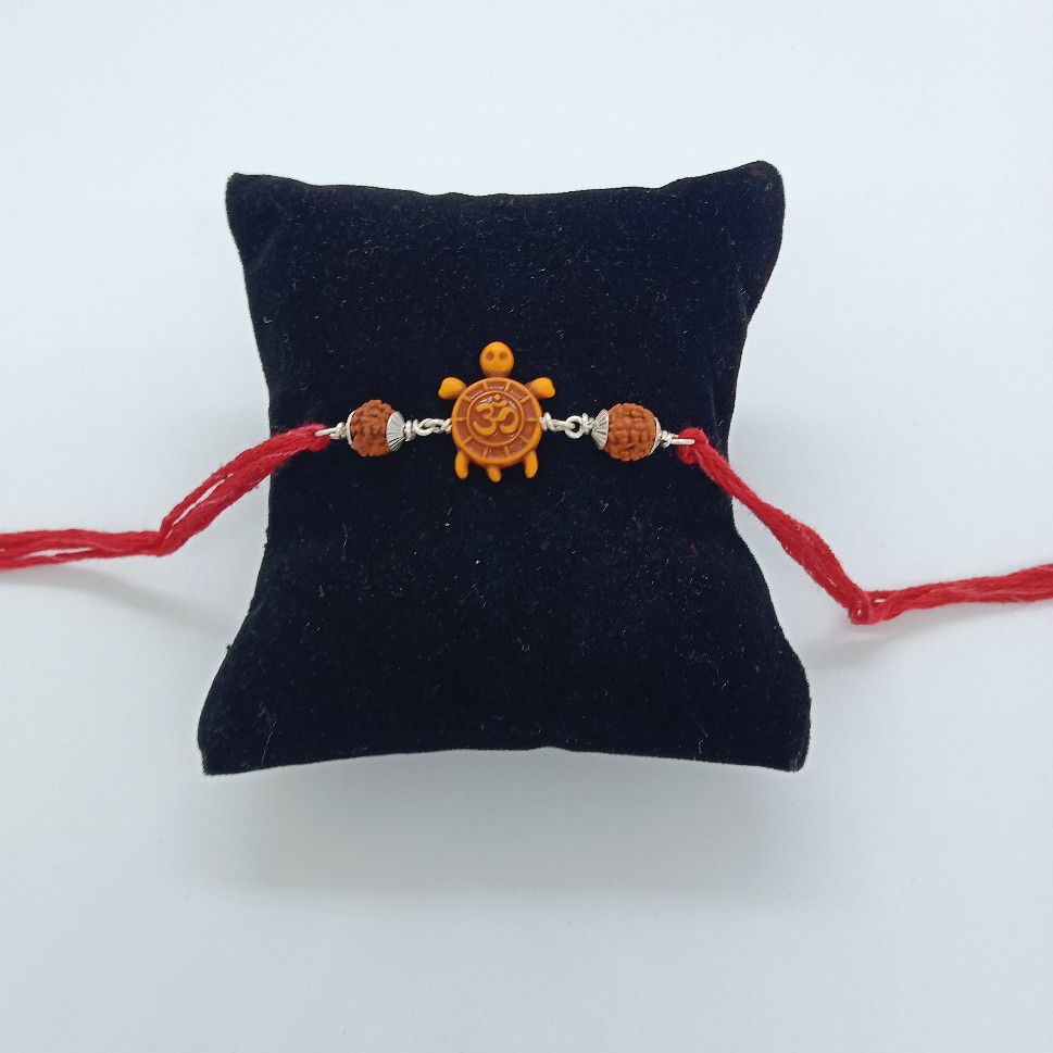 silver om design rakhi